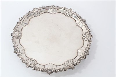 Lot 3419 - George III silver waiter of circular form with stylized shell, leaf and gadrooned border.