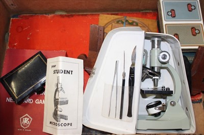 Lot 3753 - Student microscope, 1920s notebooks, various vintage games