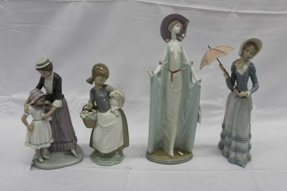 Lot 2192 - Four Lladro figures, including a lady with parasol, a lady in a long dress, mother and child, and a young shepherdess