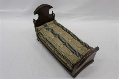 Lot 2895 - Victorian mahogany  doll's bed with stuffed and stitched mattress.