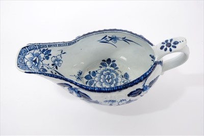 Lot 7 - 18th century Derby blue and white sauceboat, circa 1760, moulded with pears and flowers and scrolled reserves, painted with fishermen under willow trees with Chinese pagodas, 20cm length