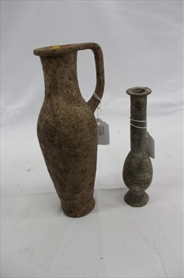 Lot 3779 - Ancient terracotta vessel, with single angular handle, 22cm high, together with another smaller. (2)