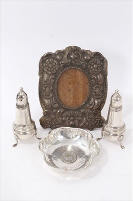 Lot 3780 - Peruvian sterling silver bon-Bon dish, of crumpled circular form, inset with Dutch coin, stamped Sterling 925, Camusso, together with a pair of baluster form pepperettes and a white metal embossed...