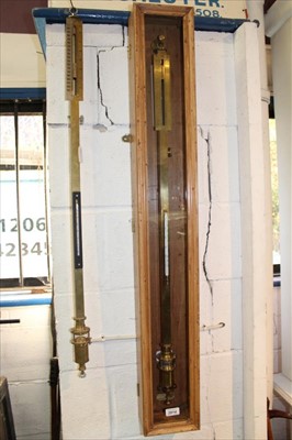 Lot 3814 - Mid 20th century brass cased stick barometer by W & J George & Becker Ltd, suspended in a pine hanging display case with glazed door, barometer 101cm long, together with another similar example, 10...