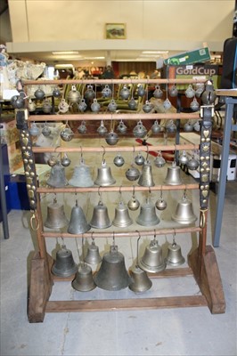 Lot 3787 - Impressive display of working horse bells, including approximately 60 bells, crotal and traditional form, 18th century and later, including examples by Robert Wells and others, the largest 14cm hig...