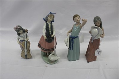 Lot 2206 - FourLladro porcelain figures - girl with flowers, two girls with hats and girl feeding duck plus Nao figure (4)