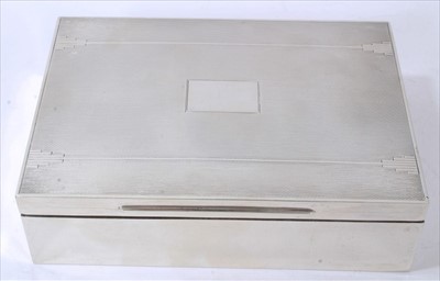 Lot 3414 - 1930 silver cigarette box of rectangular form, hinged cover with engine turned decoration and vacant cartouche, cedar lining (London 1935) 16cm across