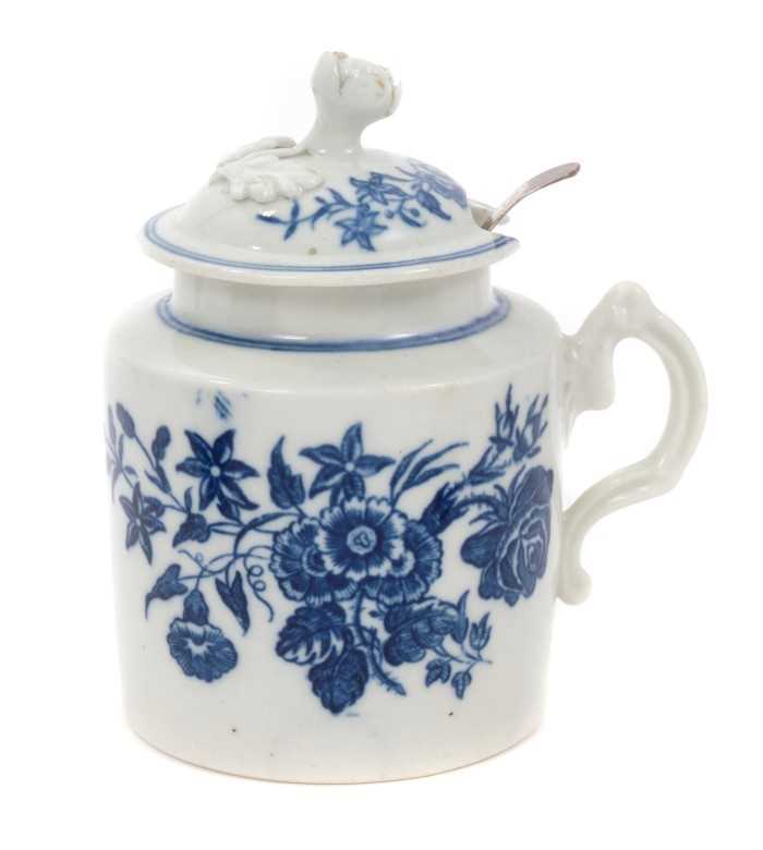 Lot 19 - 18th century Caughley mustard pot, circa 1775, decorated in underglaze blue with the 'three flowers' pattern, with contemporary Georgian silver spoon, 10cm height