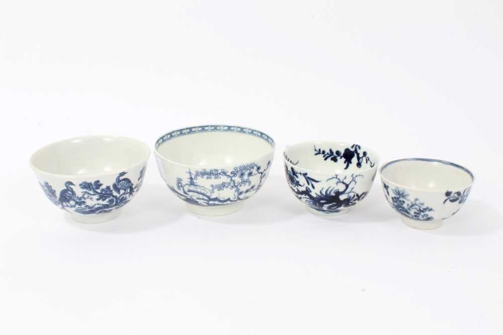 Lot 20 - Four 18th century Worcester blue and white tea bowls, to include one with Cannonball pattern, one with Birds in Branch pattern, one with Prunus Root pattern, and the other with birds flying over an...
