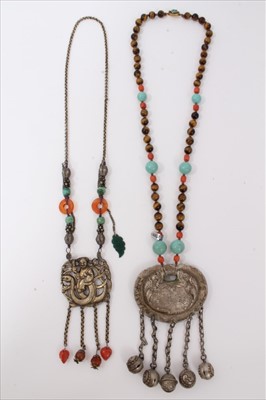 Lot 3482 - Old Chinese necklace with embossed white metal plaque with turquoise, coral and cat’s eye beads, together with another similar necklace (2)