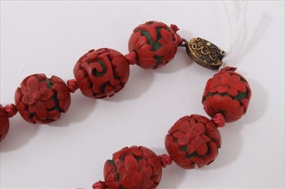 Lot 3485 - Chinese cinnabar lacquer bead necklace with 14mm-17mm diameter spherical red lacquer beads, on Chinese silver clasp.