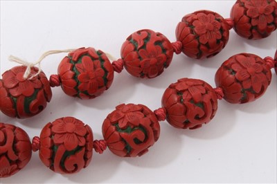 Lot 3485 - Chinese cinnabar lacquer bead necklace with 14mm-17mm diameter spherical red lacquer beads, on Chinese silver clasp.