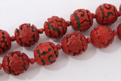 Lot 3485 - Chinese cinnabar lacquer bead necklace with 14mm-17mm diameter spherical red lacquer beads, on Chinese silver clasp.