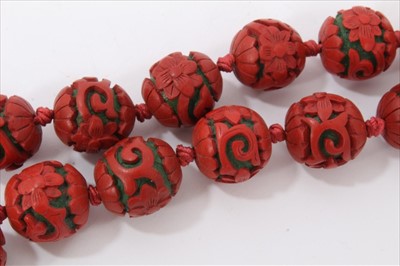 Lot 3485 - Chinese cinnabar lacquer bead necklace with 14mm-17mm diameter spherical red lacquer beads, on Chinese silver clasp.