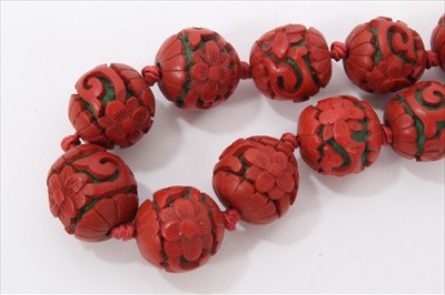 Lot 3485 - Chinese cinnabar lacquer bead necklace with 14mm-17mm diameter spherical red lacquer beads, on Chinese silver clasp.