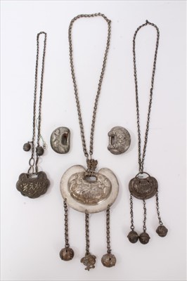 Lot 3491 - Two old Chinese white metal necklaces with embossed panels and bells