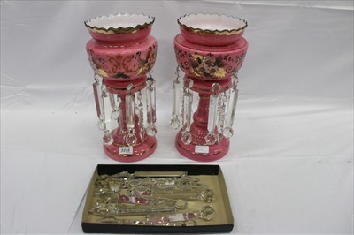 Lot 2215 - Pair of Victorian pink glass lustres, painted with flowers with gilt highlights, on wooden stands, total height 41cm