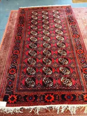 Lot 936 - Afghan rug, with repeat quartered gul motif on brick red ground