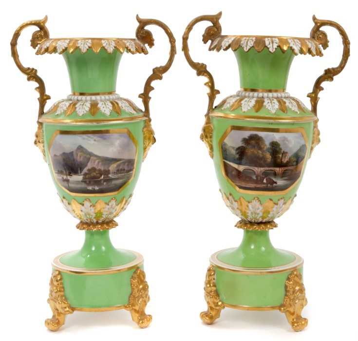 Lot 48 - Good pair of early 19th century Crown Derby twin-handled baluster vases, on circular bases with paw feet, painted with panels entitled 'View of Spain' and 'View of Wales', on a pale green ground, i...