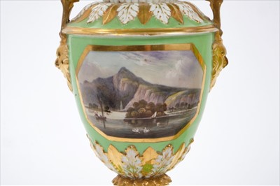 Lot 48 - Good pair of early 19th century Crown Derby twin-handled baluster vases, on circular bases with paw feet, painted with panels entitled 'View of Spain' and 'View of Wales', on a pale green ground, i...