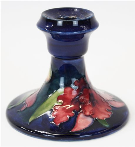 Lot 2002 - Moorcroft pottery candlestick decorated in the...