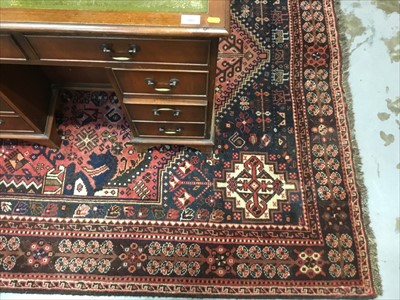 Lot 805 - An Eastern wool rug on red and blue ground