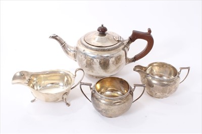 Lot 240 - Three piece silver teaset and silver gravy boat