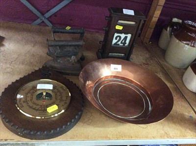 Lot 404 - Wooden date calendar desk display, barometer, two irons and copper dish