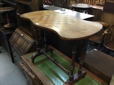 Lot 885 - Victorian walnut games table on turned standards