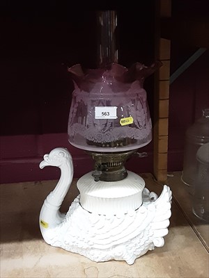 Lot 563 - Unusual late Victorian ceramic oil lamp in the form of a swan, with cranberry glass shade