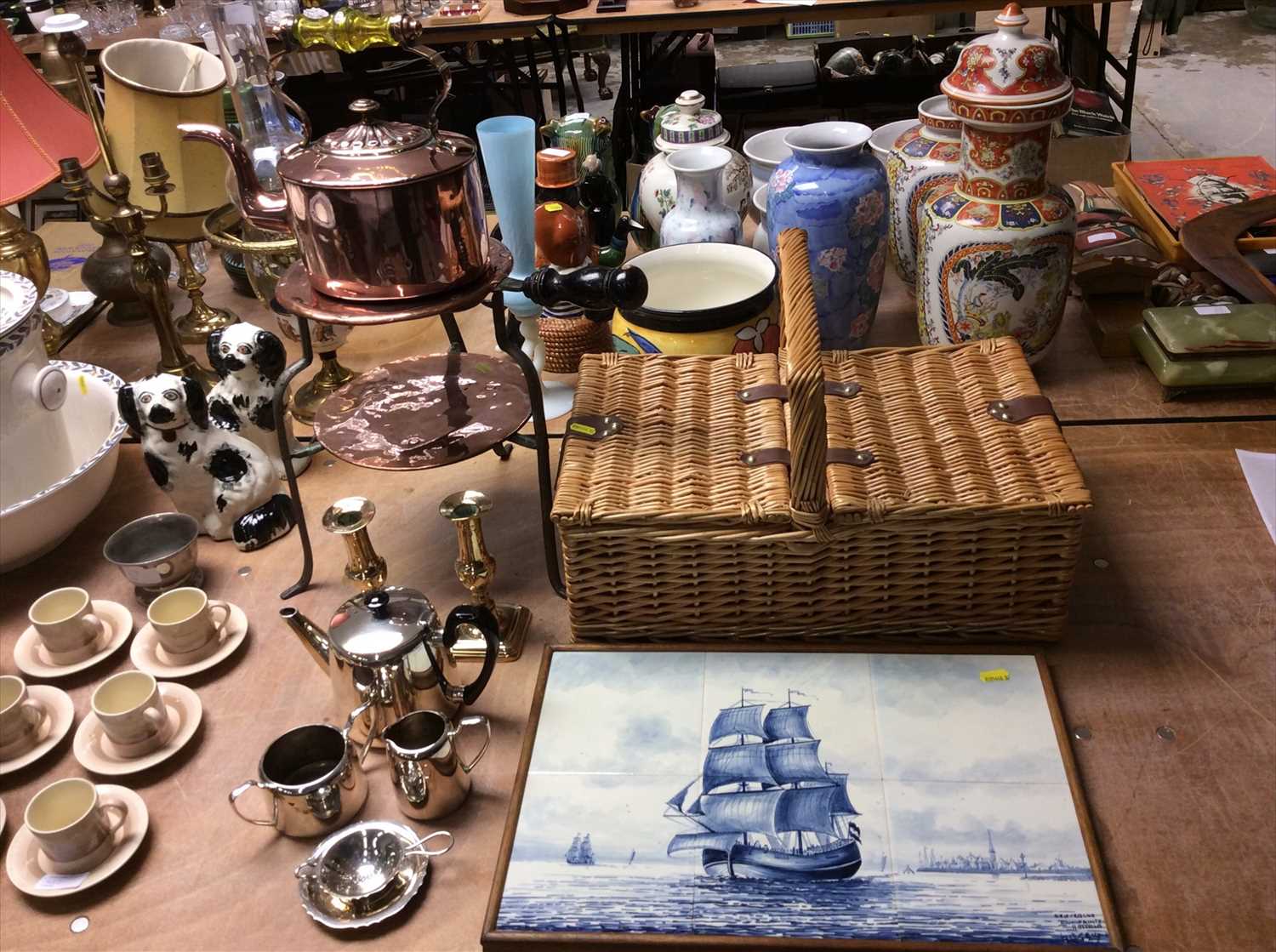 Lot 438 - Wicker hamper with contents, Victorian copper kettle and trivet, metal ware and Delft tile picture