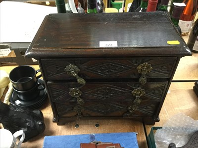 Lot 323 - Victorian carved oak miniature chest of three drawers