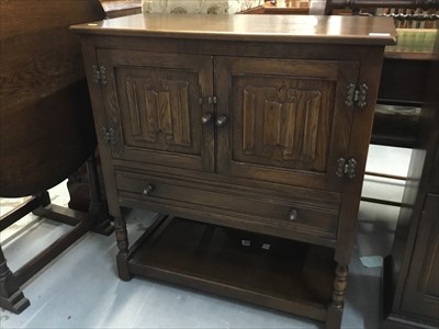 Lot 880 - Old Charm style oak cabinet with linen fold decoration