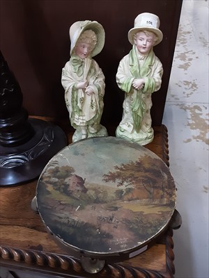 Lot 556 - Pair of late 19th Century German bisque porcelain figures and a Victorian tambourine with hand painted scene by Kitty Bridger, 20th April, 1891