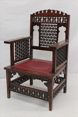 Lot 1289 - Early 20th Century Moorish style mahogany open arm chair, in the manner of Libertys