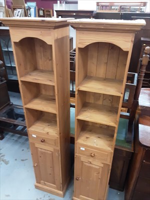 Lot 867 - Pair of pine narrow open bookcases with drawer and cupboard below