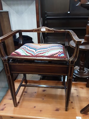 Lot 852 - Edwardian inlaid piano stool and a mahogany wine table and a revolving bookcase (3)