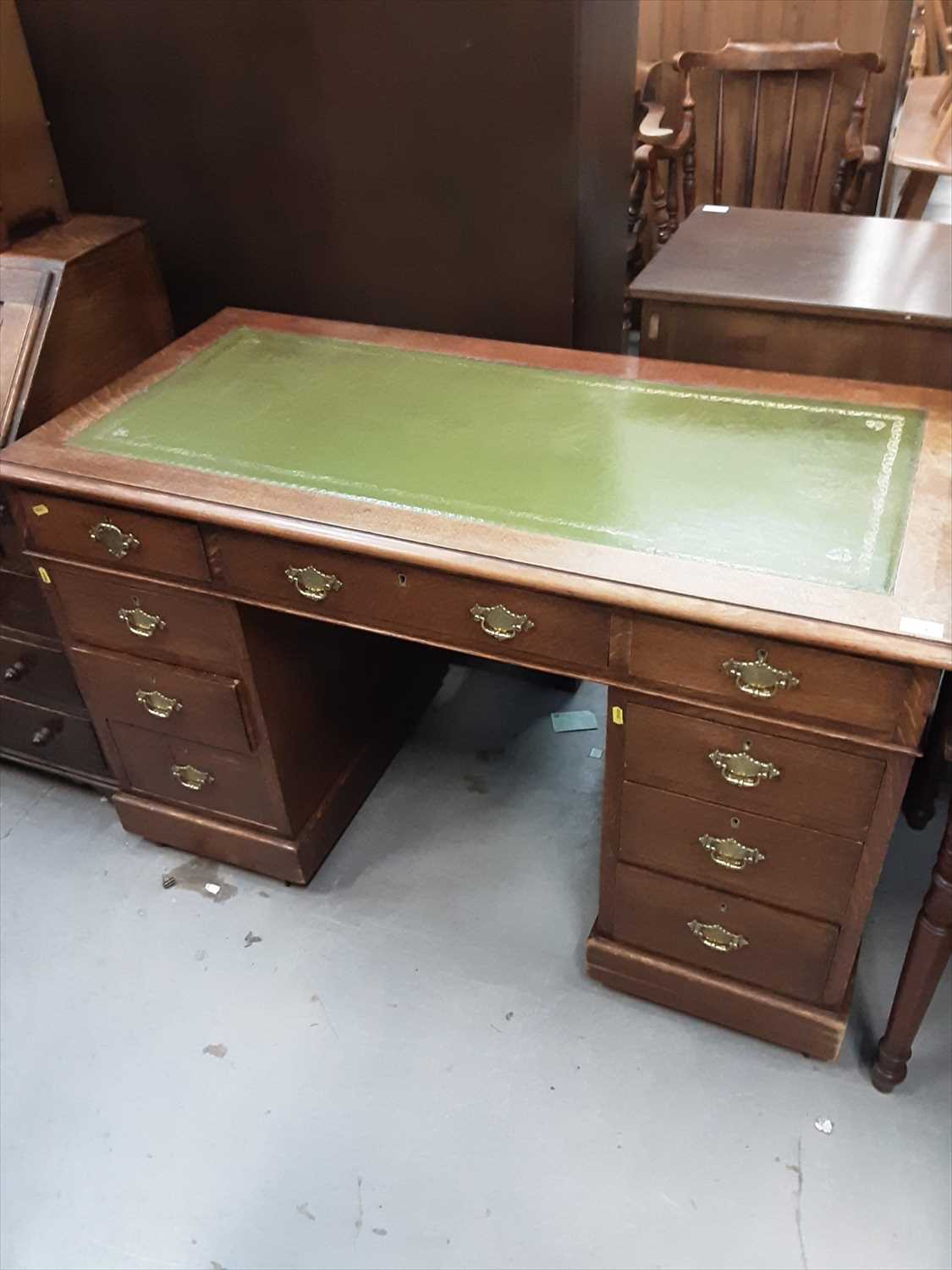 Lot 854 - Edwardian oak twin pedestal desk with inset leather lined top and nine drawers below