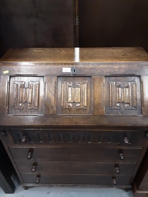 Lot 855 - Oak bureau with linenfold decoration and four drawers below and a glazed bookcase (2)