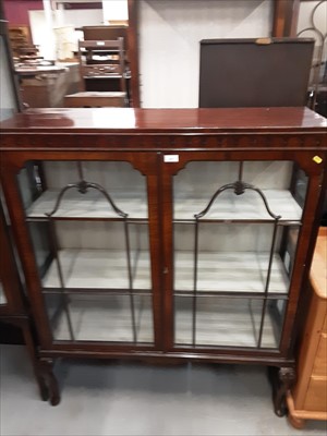 Lot 857 - 1920s mahogany display cabinet with shelved interior enclosed by two astragal glazed doors on carved cabriole legs