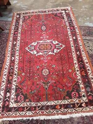 Lot 925 - Eastern rug with geometric decoration on red ground