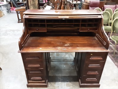 Lot 934 - Early 20th century oak roll top desk with tambour shutter and eight drawers