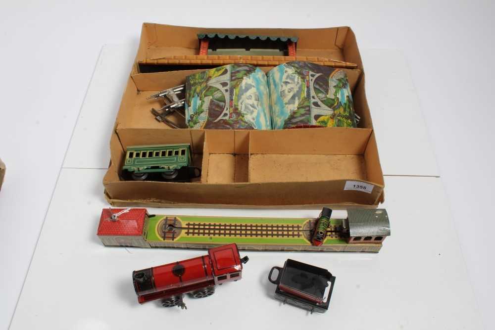 Lot 1355 - Railway tinplate clockwork set in original box plus German tinplate clockwork model of a rotating engine and carriage