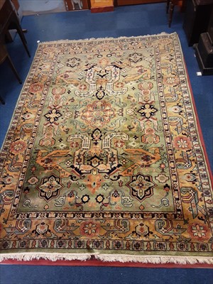 Lot 960 - Large Eastern carpet with geometric decoration on green ground