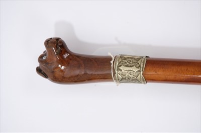 Lot 693 - Mid 19th century malacca and carved wooden stick, the handle carved as a dog's head with glass eyes, white metal embossed collar engraved 'J Hartley', brass ferrule, 80cm long