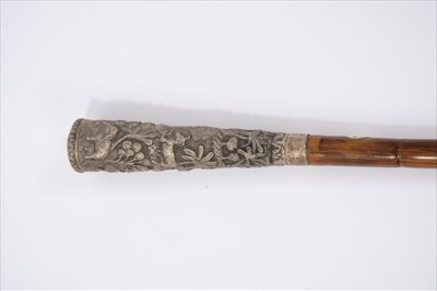 Lot 694 - 19th century Anglo-Indian white metal and cane walking stick, the tapering handle embossed with continuous frieze of animals in a jungle, 80cm long