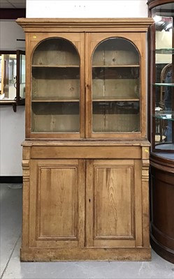 Lot 850 - Old pine two height bookcase with two glazed arched doors above, freeze drawer and two panelled doors below