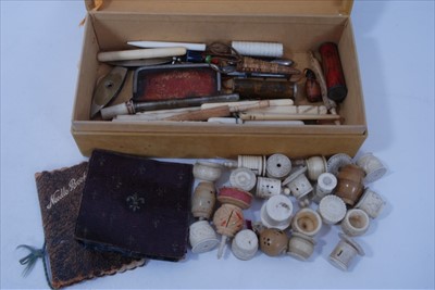 Lot 1682 - Collection antique sewing items including four carved bone needle cases in the form of umbrellas, other bone needle cases, selection of decorative silk thread winders etc