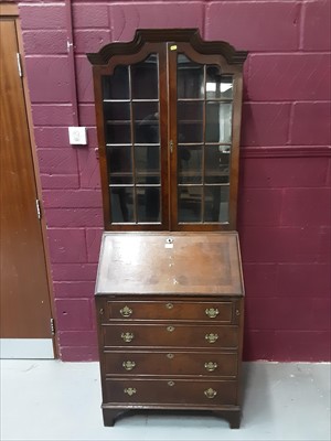 Lot 883 - Antique style walnut bureau bookcase with two glazed doors above, fitted interior and four long drawers below