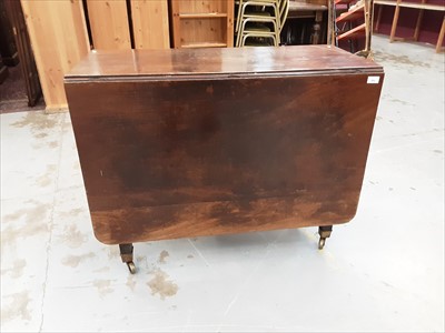 Lot 892 - George mahogany drop leaf table on square legs and brass capped castors